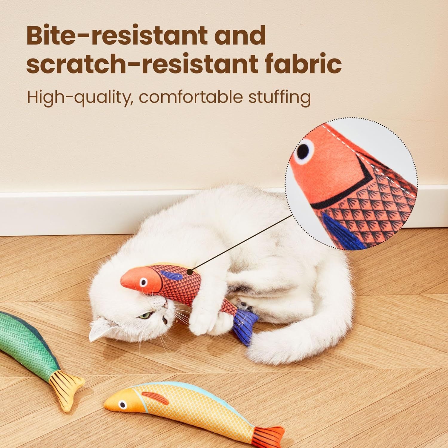 White cat biting red saury fish catnip toy showing bite-resistant fabric